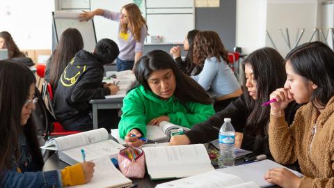 Multicultural high school classroom with active discussion groups