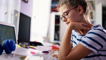 high school student reading text passage at home