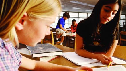 Two middle school students working on fluency in class