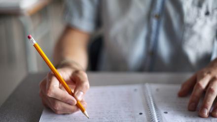 Young man writing a multi-paragraph essay